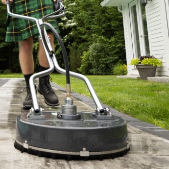 A professional grade pressure washer being controlled by a Men In Kilts technician.